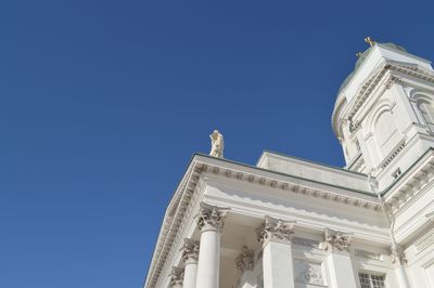 Low angle view of white building against clear blue sky