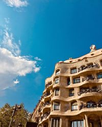 Low angle view of buildings against blue sky