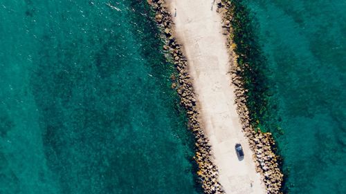 Aerial view of road amidst sea