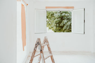 Ladders and painter tools on white room at construction site. painting walls. home improvement