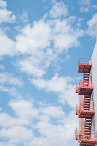 Low angle view of staircase against cloudy sky