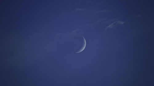 Low angle view of moon in sky at night