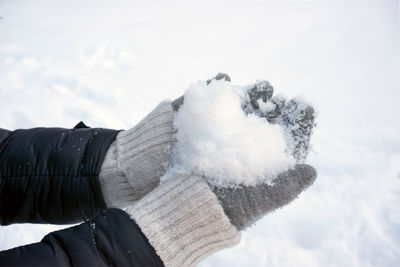 Person holding ice cream against sky