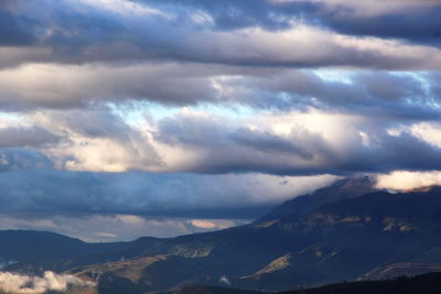 Scenic view of mountains against cloudy sky