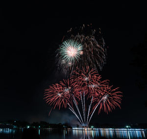 Low angle view of firework display at night