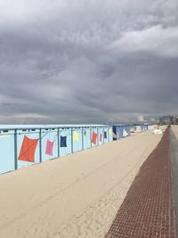 Multi colored umbrellas on beach against sky
