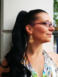 Smiling woman in eyeglasses looking away