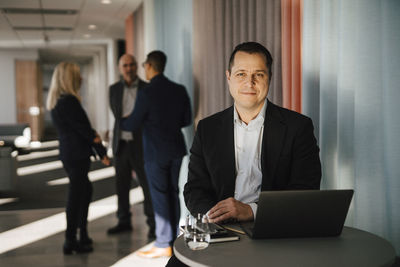 Man with laptop sitting in office