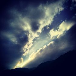 Low angle view of silhouette mountain against sky