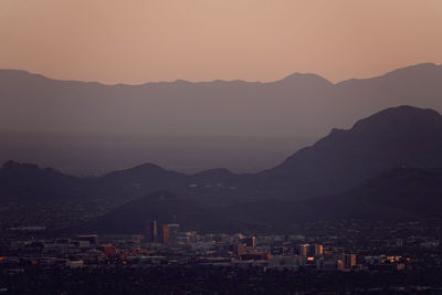 High angle view of downtown tucson and surrounding mountains with orange sunset sky