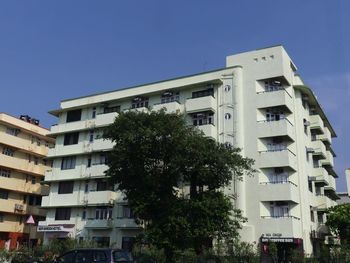 Low angle view of buildings against clear blue sky