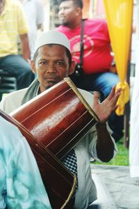 Portrait of mature man playing drum