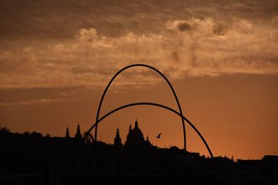 Silhouette of built structure at sunset