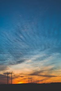 Low angle view of electricity pylon against sky