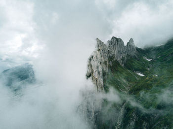 Idyllic shot of rocky mountains during foggy weather