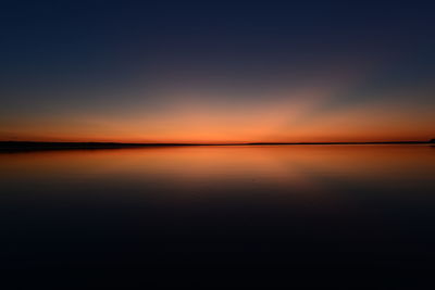 Scenic view of sea against sky at sunset