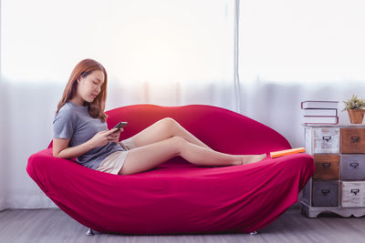 Young woman sitting on mobile phone