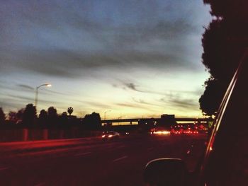 Road against cloudy sky at dusk