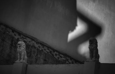 Statue of buddha against wall