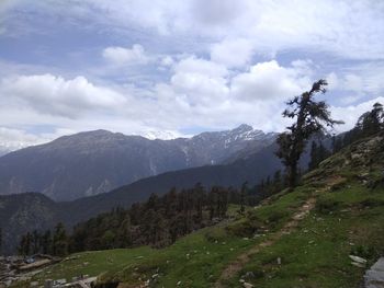 Scenic view of mountains against cloudy sky