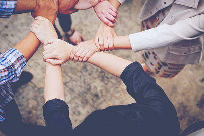 High angle view of people with hands