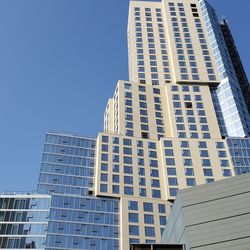 Low angle view of modern building against clear blue sky