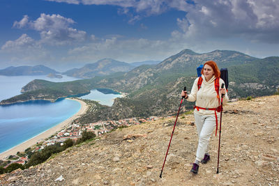 Man standing on mountain against sky