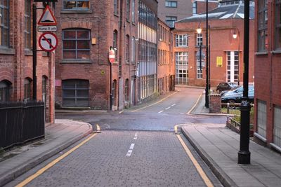 Road amidst buildings in city