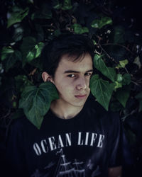 Portrait of young man against plants