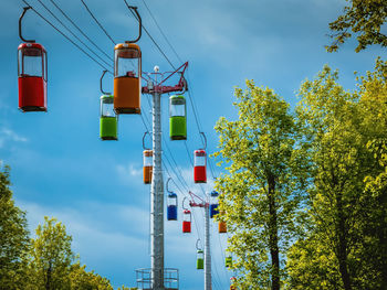 Low angle view of road signal against blue sky