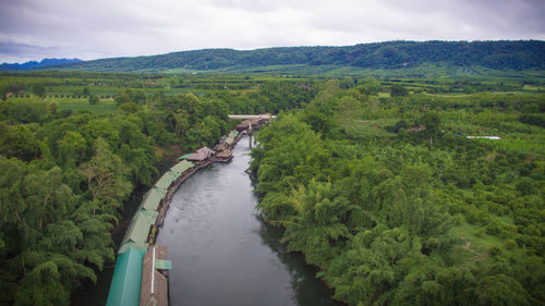 Scenic view of river against cloudy sky