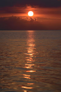 Scenic view of sea against orange sky