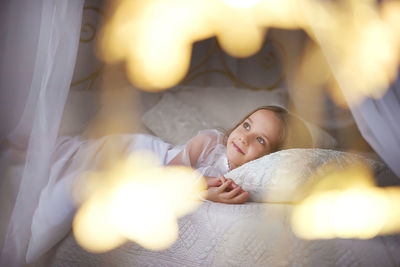 Cute girl lying on bed at home