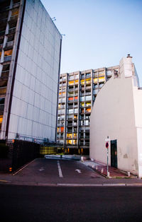 Street amidst buildings against clear sky