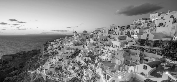 High angle view of townscape by sea against sky