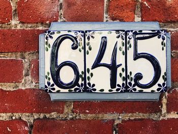 Close-up of text on brick wall