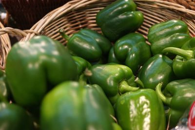 Close-up of green chili peppers in basket for sale