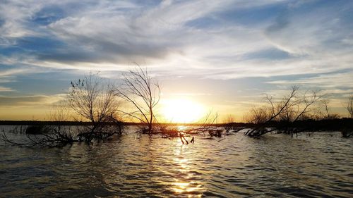 Scenic view of lake against sky during sunset