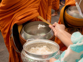 Midsection of woman preparing food at table