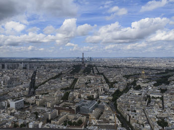 View of cityscape against cloudy sky