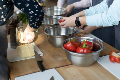 Midsection of woman preparing food in kitchen at home