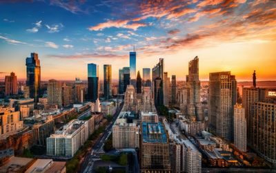 Buildings in city against sky during sunset