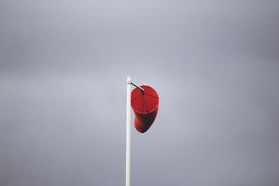 Low angle view of red wind sock against sky