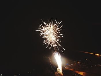 Low angle view of firework display at night