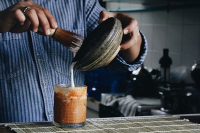 Midsection of man having coffee