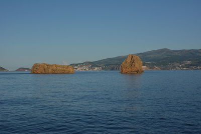 Scenic view of sea against clear blue sky