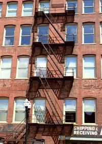 Low angle view of fire escape on building during sunny day