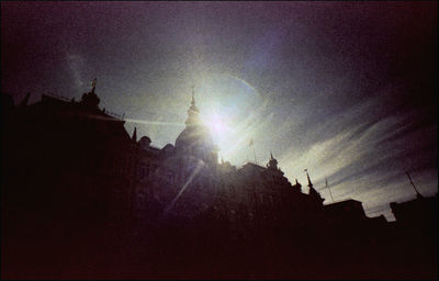 Low angle view of silhouette buildings against sky during sunset