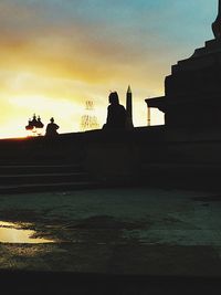 Silhouette built structures at sunset