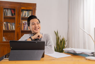 Young woman using laptop at office